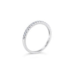 Platinum diamond wedding ring featuring seventeen claw-set round brilliant cut diamonds across the band.