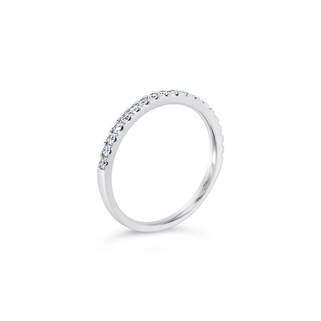 Platinum diamond wedding ring featuring seventeen claw-set round brilliant cut diamonds across the band.