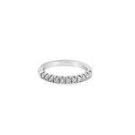 Platinum wedding ring featuring eleven claw-set round brilliant cut diamonds across the top of the band.