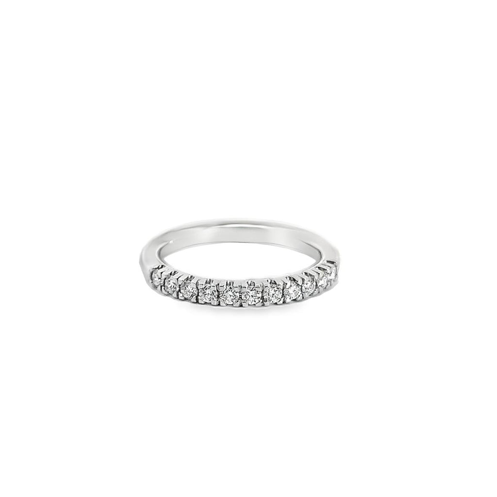 Platinum wedding ring featuring eleven claw-set round brilliant cut diamonds across the top of the band.