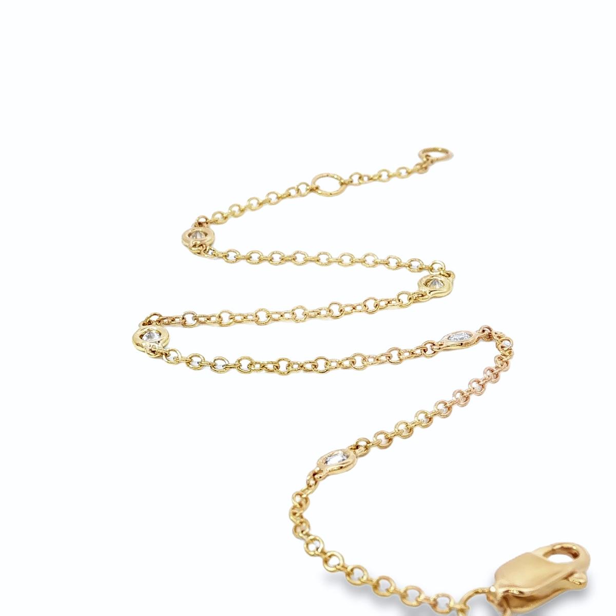 18ct yellow gold bracelet with bezel set diamond stations along fine chain
