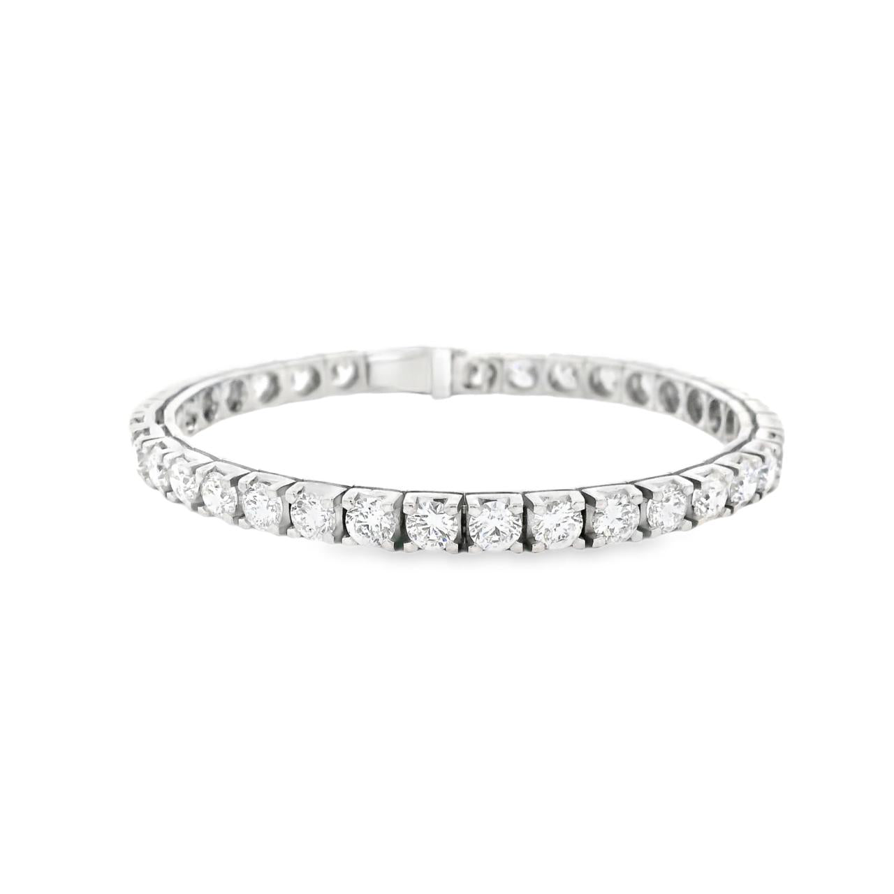 18ct white gold diamond tennis bracelet featuring thirty-six round brilliant cut diamonds totalling 11.36ct, in four-claw settings with a secure slide catch and fold-over clasps.