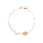 14ct rose gold diamond tennis bracelet featuring a fine adjustable trace link chain and a central tennis racquet charm set with a 0.03ct round brilliant cut diamond.
