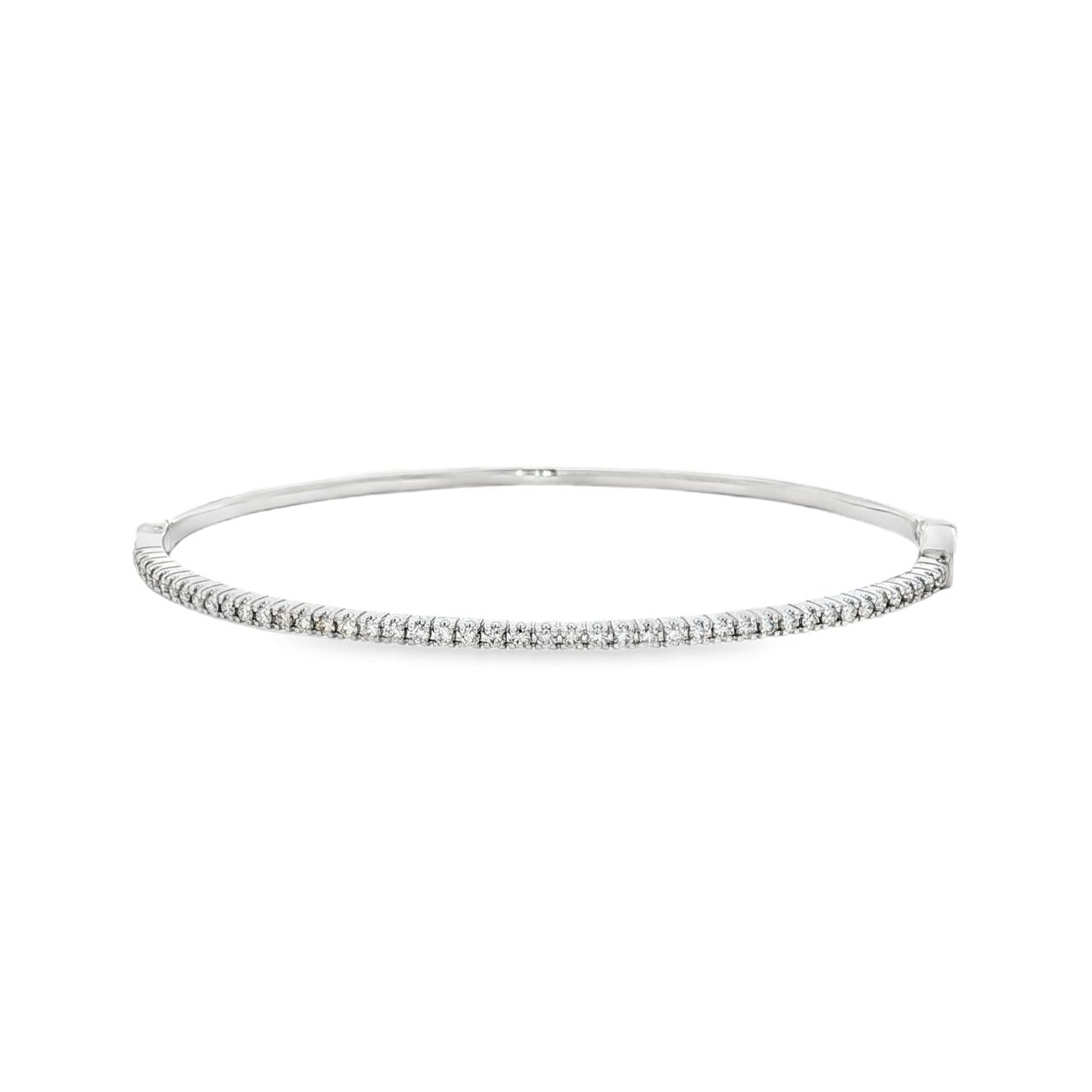 18ct white gold diamond bangle featuring forty-five claw-set round brilliant cut diamonds across the top, oval profile with hinged opening and slide catch fastening.