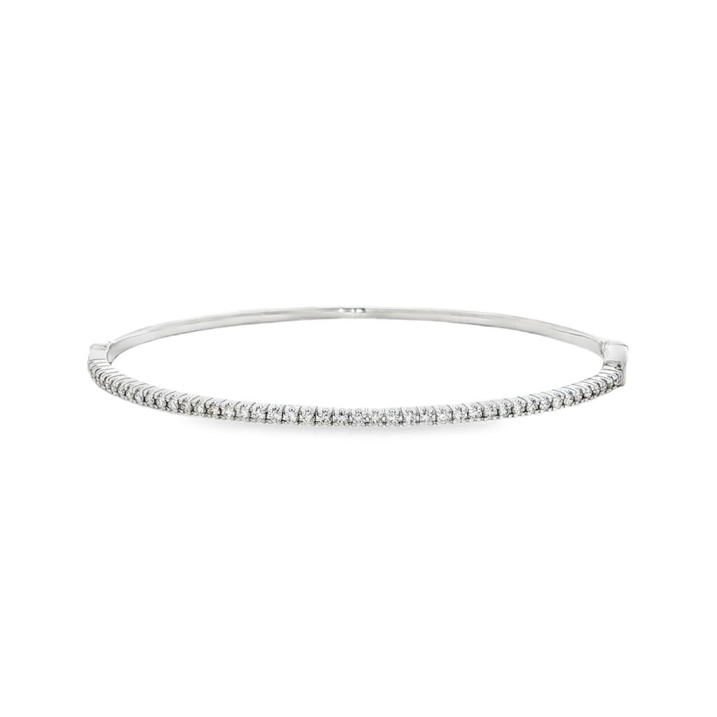 18ct white gold diamond bangle featuring forty-five claw-set round brilliant cut diamonds across the top, oval profile with hinged opening and slide catch fastening.