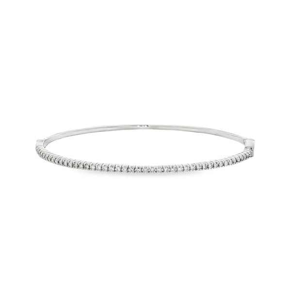 18ct white gold diamond bangle featuring forty-five claw-set round brilliant cut diamonds across the top, oval profile with hinged opening and slide catch fastening.