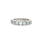 18ct white gold ring featuring seven round brilliant cut diamonds totalling 1.38ct in a straight row shared claw setting with curved undercarriage.