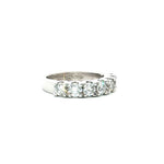 18ct white gold ring featuring seven round brilliant cut diamonds totalling 1.38ct in a straight row shared claw setting with curved undercarriage.