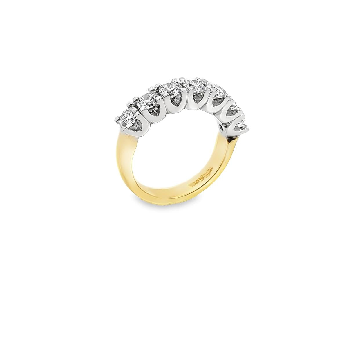 18ct yellow and white gold ring featuring seven round brilliant cut diamonds totalling 1.38ct in a shared claw setting with curved undercarriage.