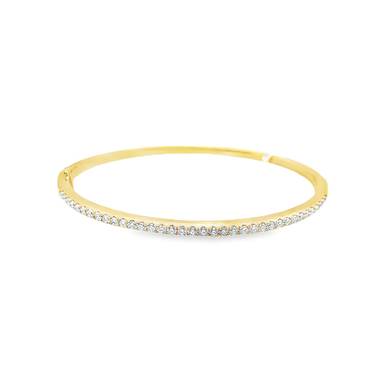 18ct yellow gold diamond bangle featuring thirty-six claw-set round brilliant cut diamonds across the top, with a hinged oval profile and secure clasp.