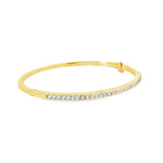 18ct yellow gold diamond bangle featuring thirty-six claw-set round brilliant cut diamonds across the top, with a hinged oval profile and secure clasp.