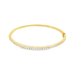 18ct yellow gold diamond bangle featuring thirty-six claw-set round brilliant cut diamonds across the top, with a hinged oval profile and secure clasp.