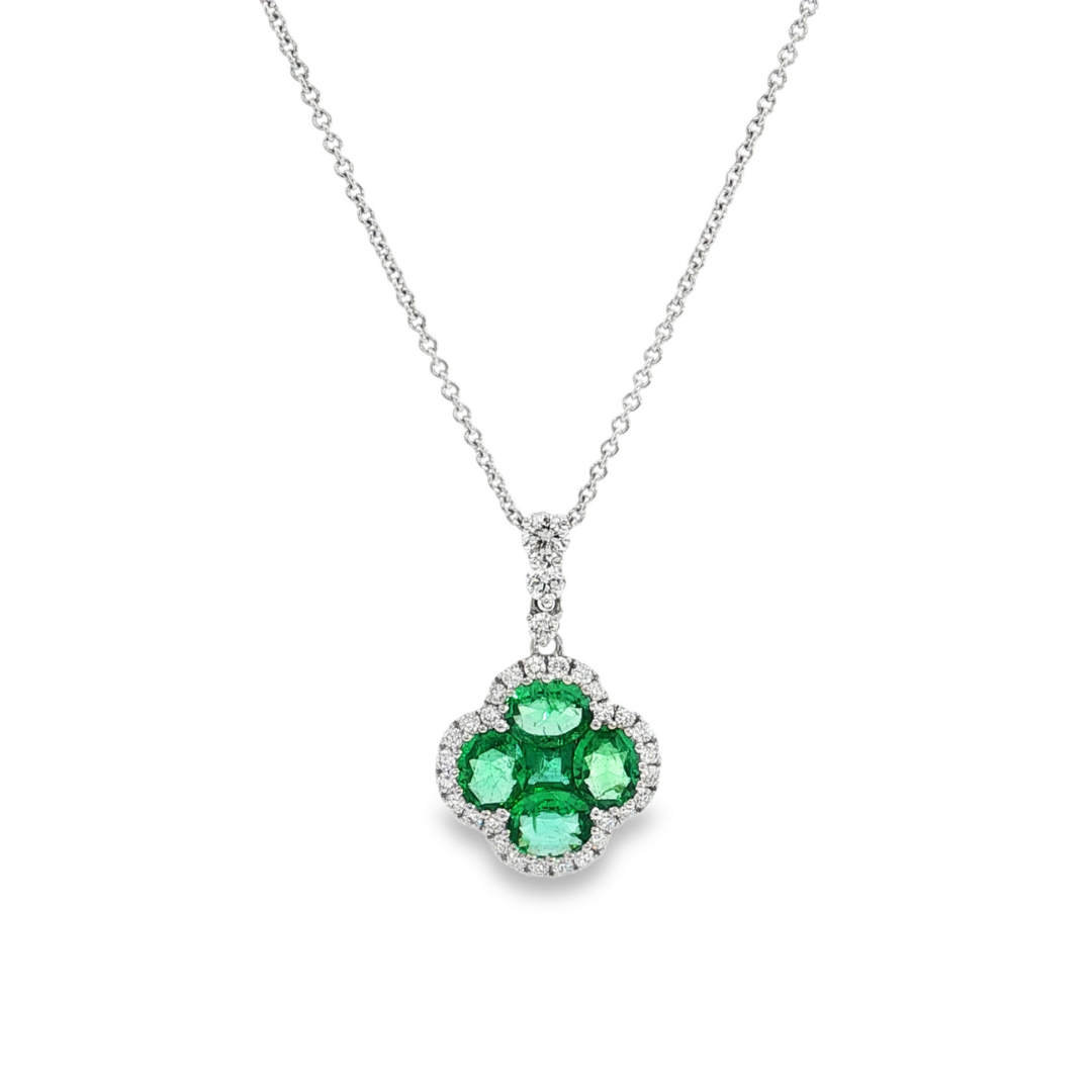 18ct white gold clover-shaped pendant featuring a cluster of princess and oval-cut emeralds surrounded by round brilliant cut diamonds with a graduating diamond-set pendant runner.