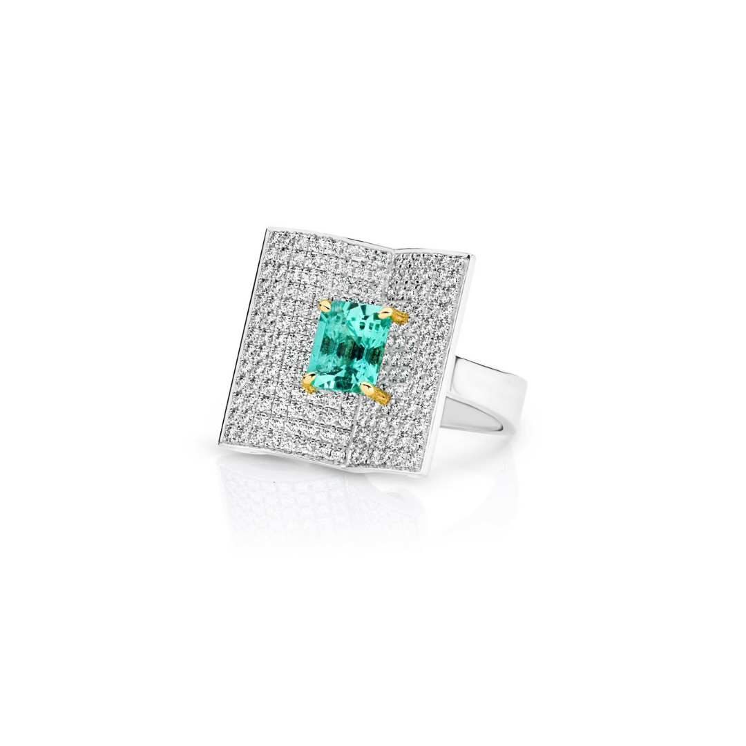 Platinum emerald and diamond ring featuring a 2.93ct emerald-cut centre stone with pavé diamond open book–style surround.