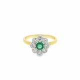 9ct yellow and white gold emerald and diamond ring featuring a round emerald surrounded by eight diamonds in a classic posy-style floral cluster design.