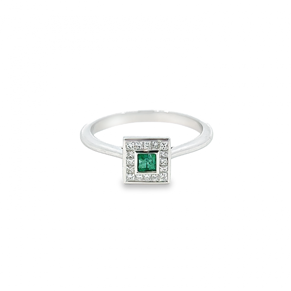 18ct white gold ring featuring a 0.17ct square emerald in a rubbed-in setting surrounded by princess cut diamonds totalling 0.22ct.