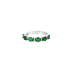 18ct white gold ring featuring alternating claw-set oval-cut emeralds and round brilliant cut diamonds in a horizontal design across the top.