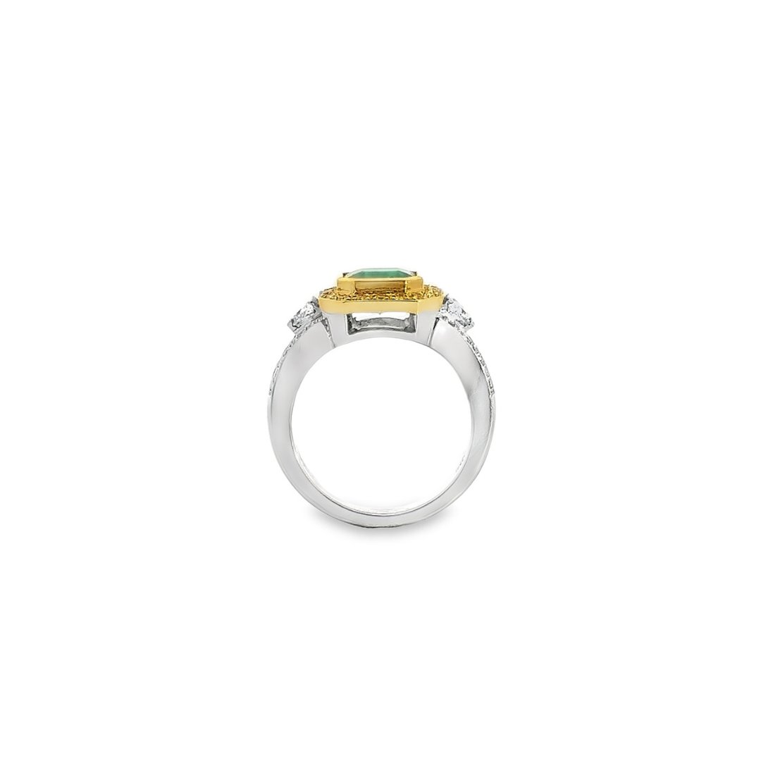 18ct ring featuring a 1.40ct square emerald-cut emerald with trapezoid side diamonds and a halo of yellow and white round brilliant cut diamonds.