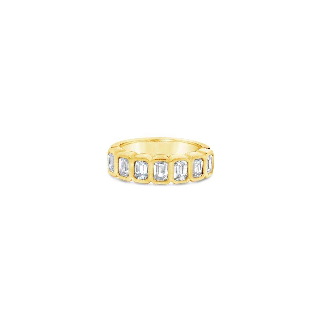 18ct yellow gold diamond ring featuring seven emerald cut diamonds in a straight row bezel setting across the top.