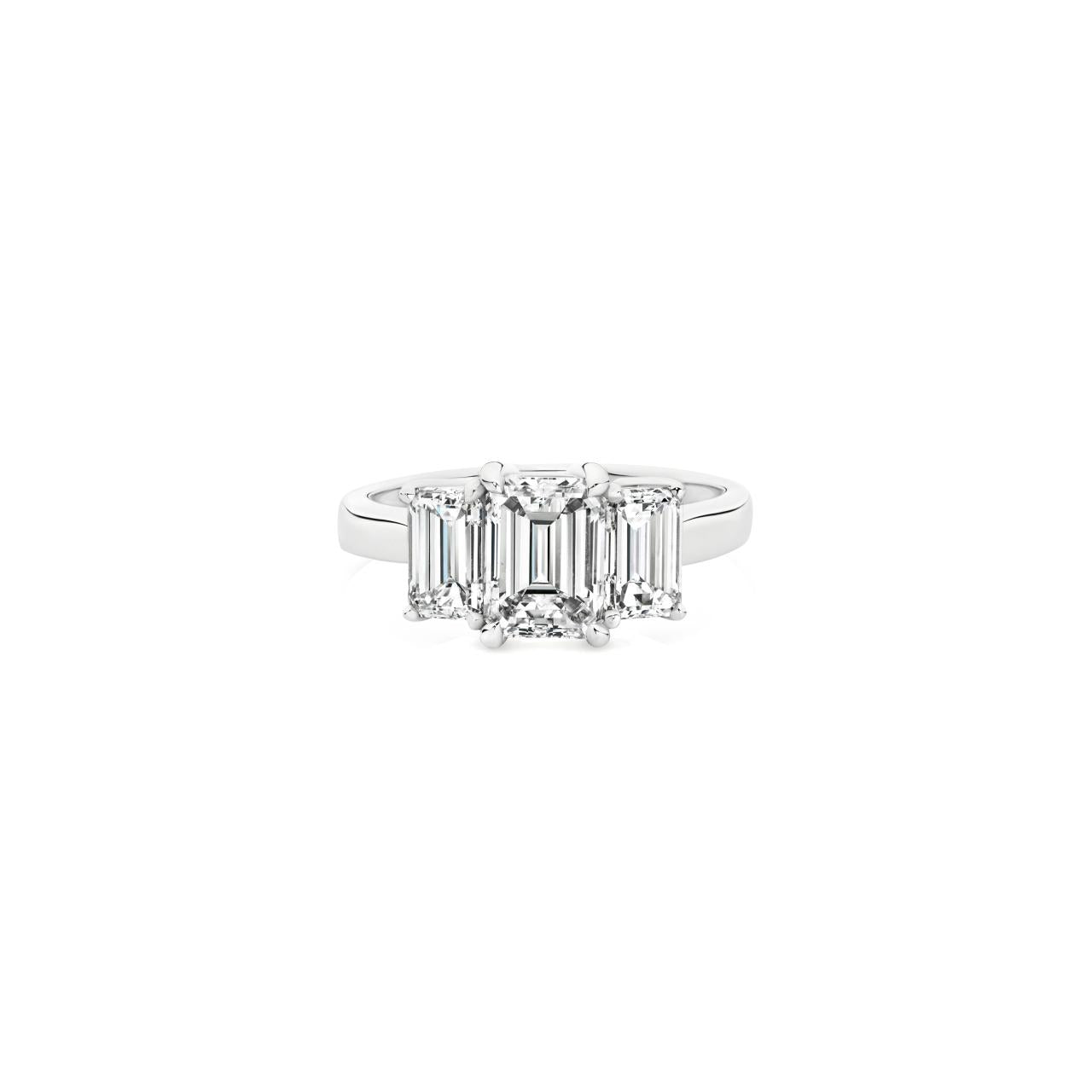 Platinum three-stone diamond ring featuring three emerald-cut diamonds in a tiered setting with post and double-bearing undercarriage, centre 2.00ct G/SI1, side stones 0.86ct F/VVS2 and 0.84ct F/VS1.