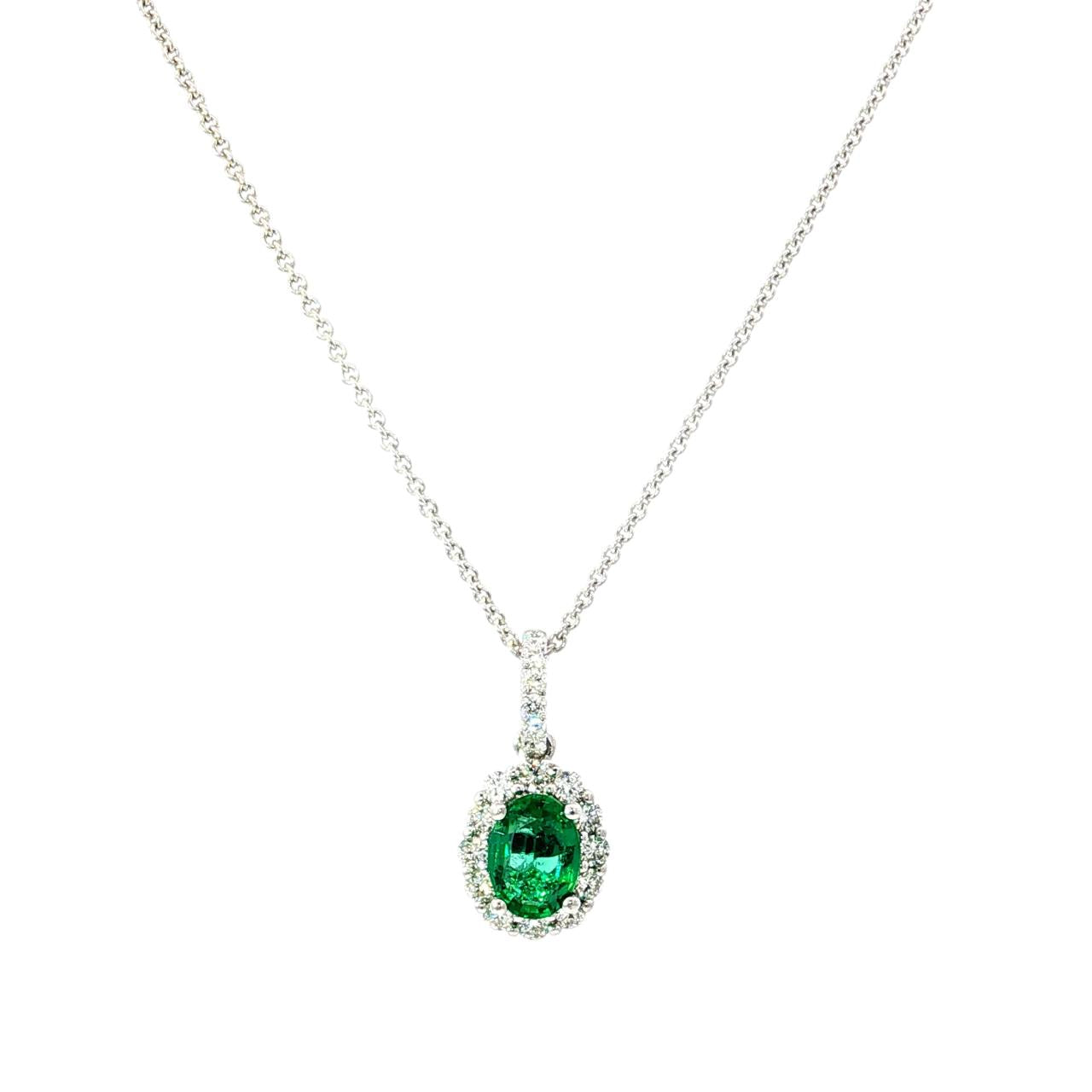 18ct white gold emerald and diamond pendant with oval emerald and halo design