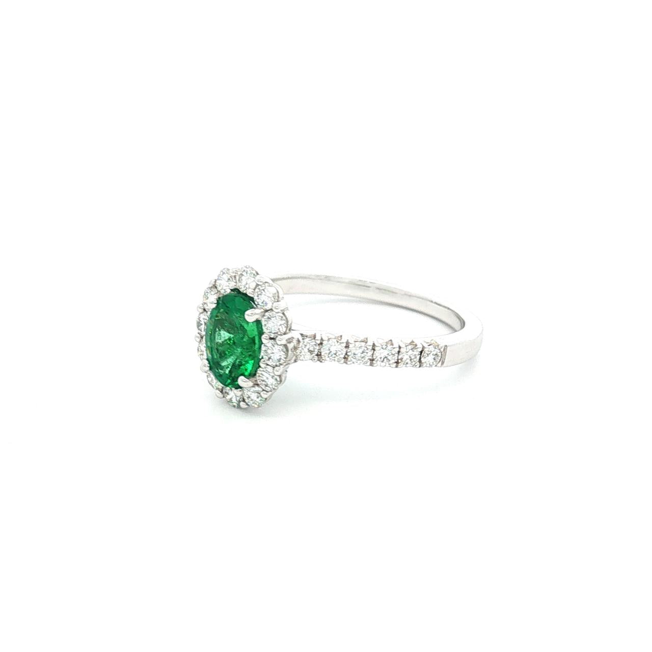 18ct white gold emerald and diamond ring with oval emerald and halo design