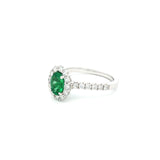 18ct white gold emerald and diamond ring with oval emerald and halo design