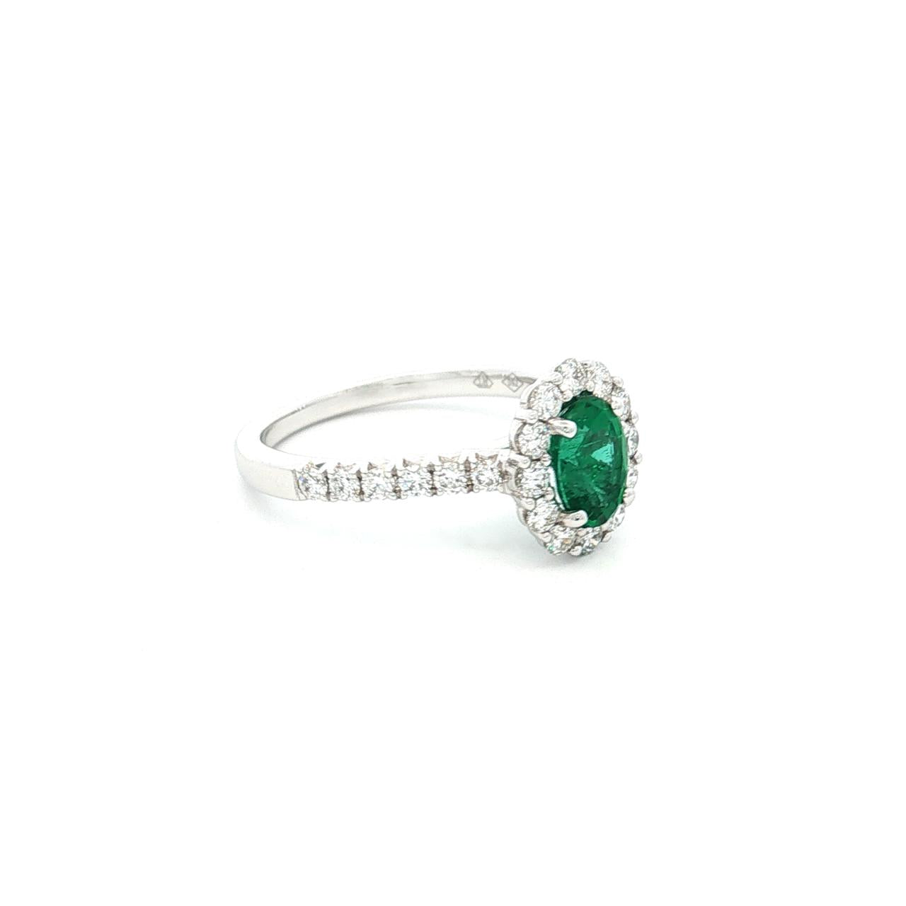 18ct white gold emerald and diamond ring with oval emerald and halo design