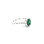 18ct white gold emerald and diamond ring with oval emerald and halo design
