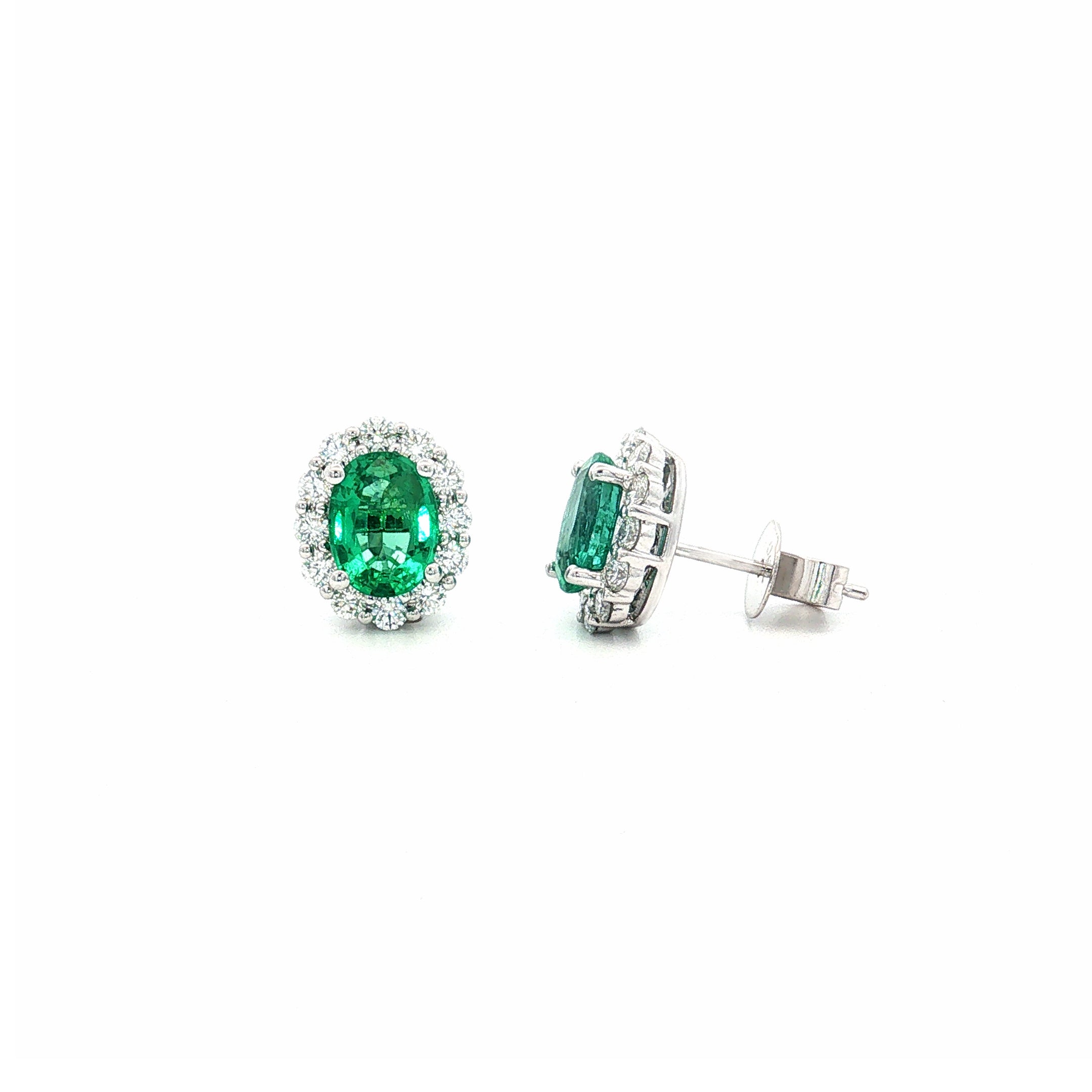 18ct white gold emerald and diamond stud earrings with oval emeralds and halo design