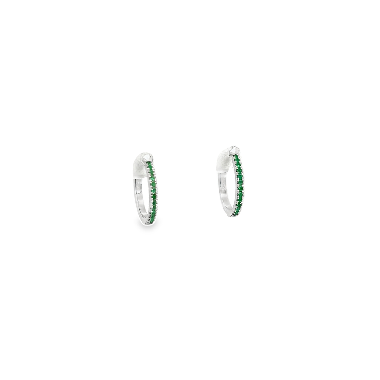 18ct white gold huggie earrings featuring claw-set emeralds along the front and back, medium size with 11mm inside diameter and hinged fittings.