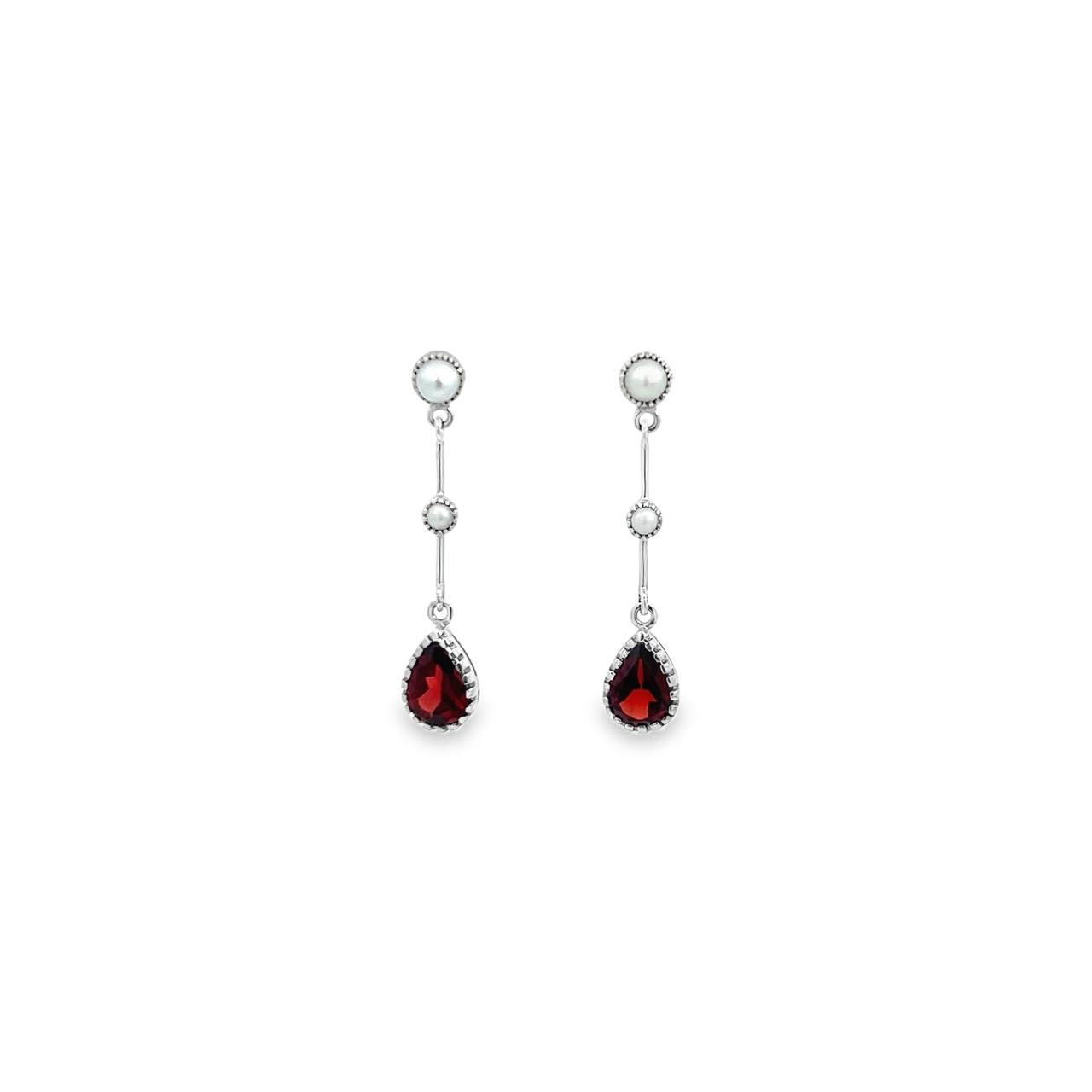 9ct white gold drop earrings featuring seed pearl accents and pear-shaped garnet drops with stud fittings and articulated bar design.