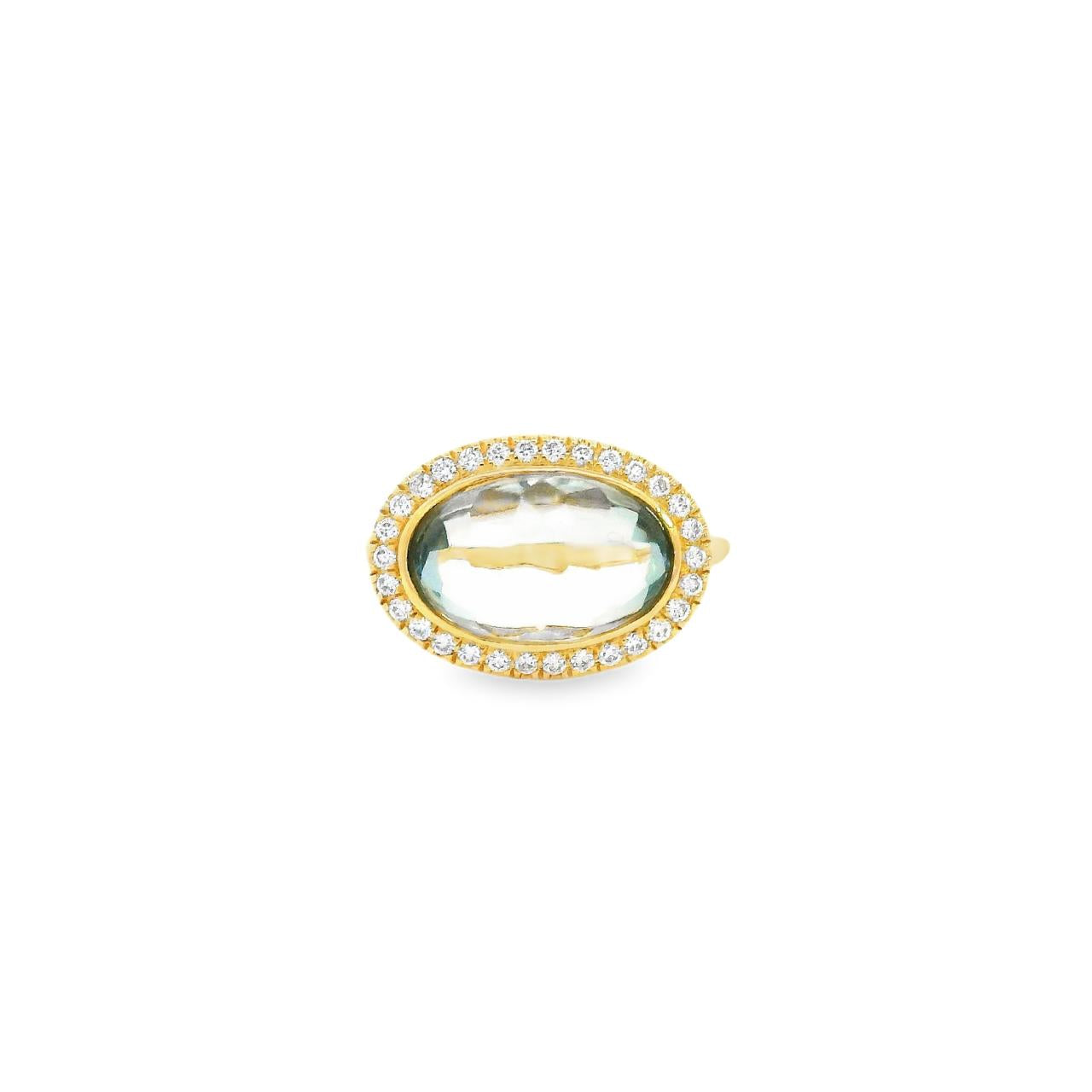 18ct yellow gold ring featuring a 4.13ct oval cabochon green quartz in a horizontal bezel setting with a diamond halo cluster in white gold.