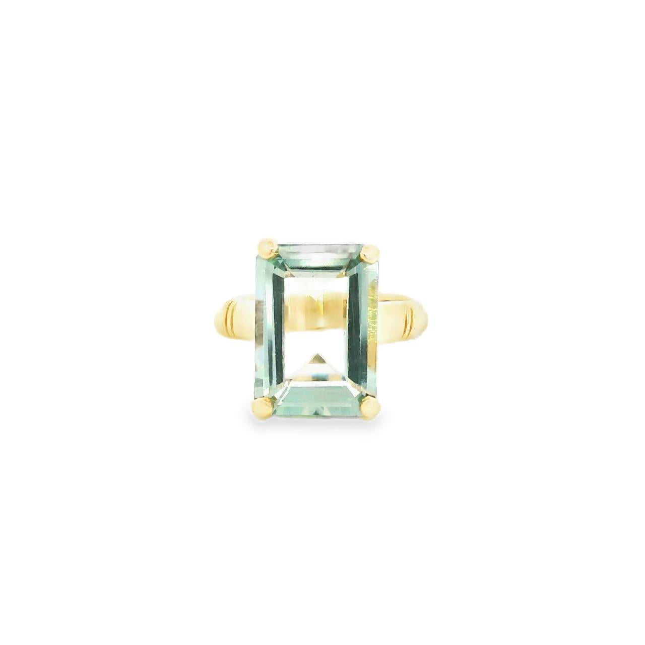 9ct yellow gold ring featuring a 14 x 10mm emerald cut green quartz in a four-claw setting with engraved shoulders.