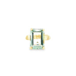 9ct yellow gold ring featuring a 14 x 10mm emerald cut green quartz in a four-claw setting with engraved shoulders.