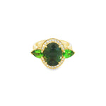 18ct yellow gold ring featuring oval green sapphire, tsavorite garnets, and diamond halo design with intricate undercarriage detail.
