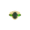 18ct yellow gold ring featuring oval green sapphire, tsavorite garnets, and diamond halo design with intricate undercarriage detail.