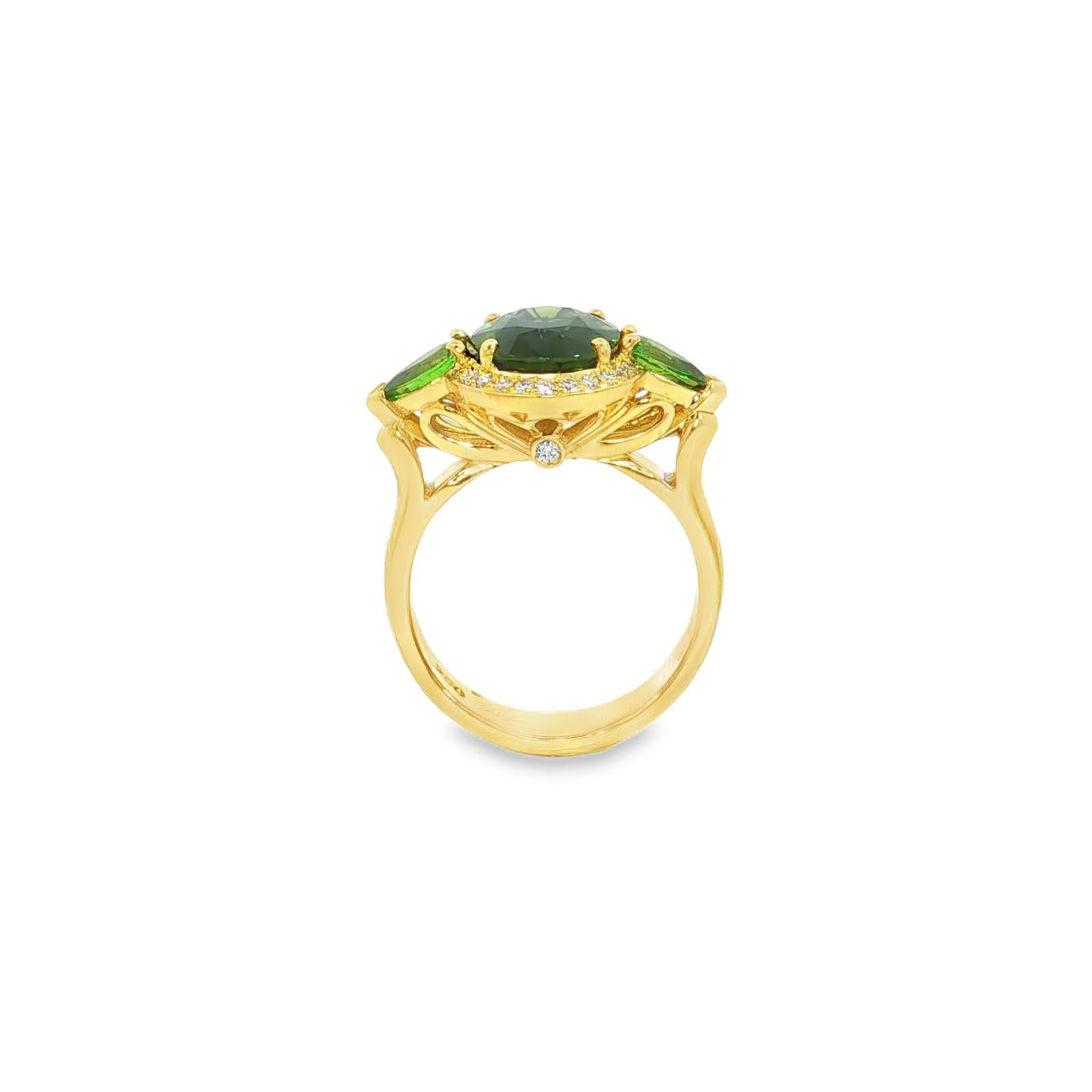 18ct yellow gold ring featuring oval green sapphire, tsavorite garnets, and diamond halo design with intricate undercarriage detail.