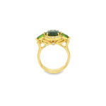 18ct yellow gold ring featuring oval green sapphire, tsavorite garnets, and diamond halo design with intricate undercarriage detail.