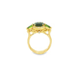 18ct yellow gold ring featuring oval green sapphire, tsavorite garnets, and diamond halo design with intricate undercarriage detail.