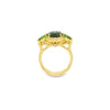 18ct yellow gold ring featuring oval green sapphire, tsavorite garnets, and diamond halo design with intricate undercarriage detail.