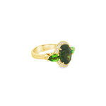 18ct yellow gold ring featuring oval green sapphire, tsavorite garnets, and diamond halo design with intricate undercarriage detail.