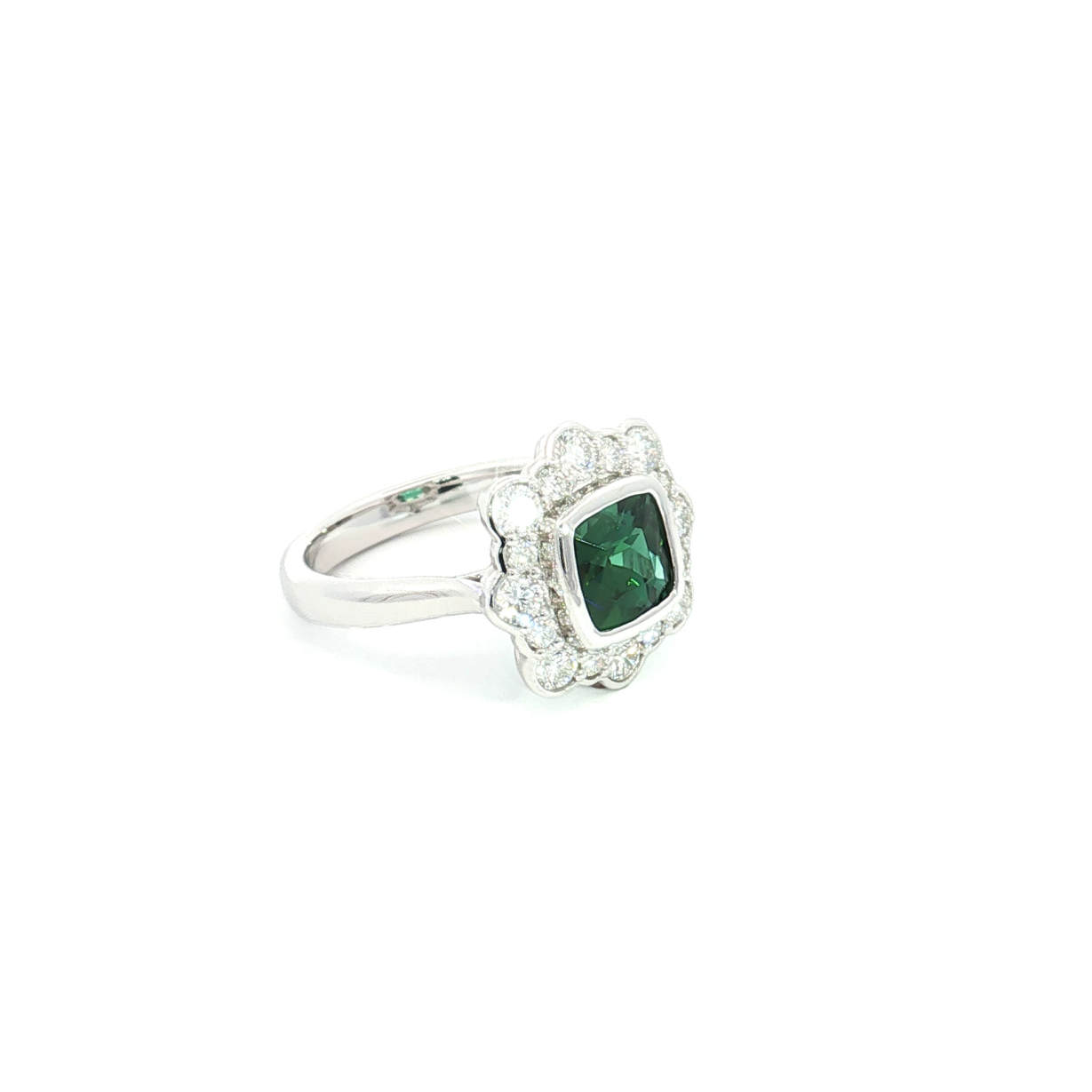 18ct white gold ring featuring a 1.61ct cushion cut green tourmaline with alternating claw and semi-bezel set diamond surround.