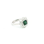 18ct white gold ring featuring a 1.61ct cushion cut green tourmaline with alternating claw and semi-bezel set diamond surround.