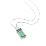 18ct white gold pendant featuring a 4.24ct rectangular cut green tourmaline and bezel-set shield diamond on a fine trace link chain.