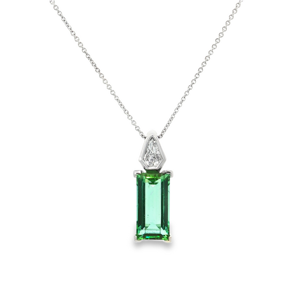 18ct white gold pendant featuring a 4.24ct rectangular cut green tourmaline and bezel-set shield diamond on a fine trace link chain.
