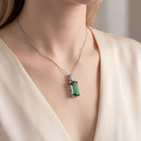 18ct white gold pendant featuring a 4.24ct rectangular cut green tourmaline and bezel-set shield diamond on a fine trace link chain.