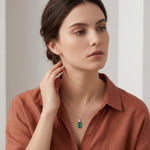 18ct white gold pendant featuring a 4.24ct rectangular cut green tourmaline and bezel-set shield diamond on a fine trace link chain.