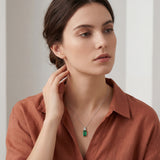 18ct white gold pendant featuring a 4.24ct rectangular cut green tourmaline and bezel-set shield diamond on a fine trace link chain.