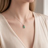 18ct white gold pendant featuring a 4.24ct rectangular cut green tourmaline and bezel-set shield diamond on a fine trace link chain.